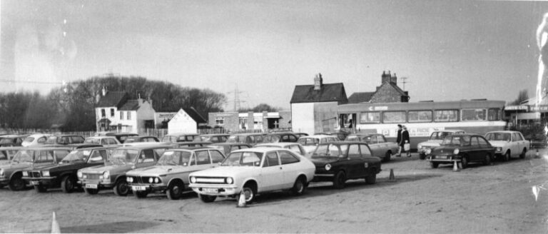 Oxford Park And Ride in 1973. A black and white photo of a car park with a bus in the back ground.
