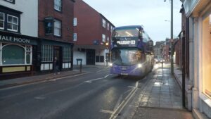 A Bus in St Clements in the dusk. Little other traffic is visible