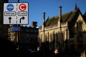 Temporary Congestion Charge sign and Bus Gate sign on Oxford High St